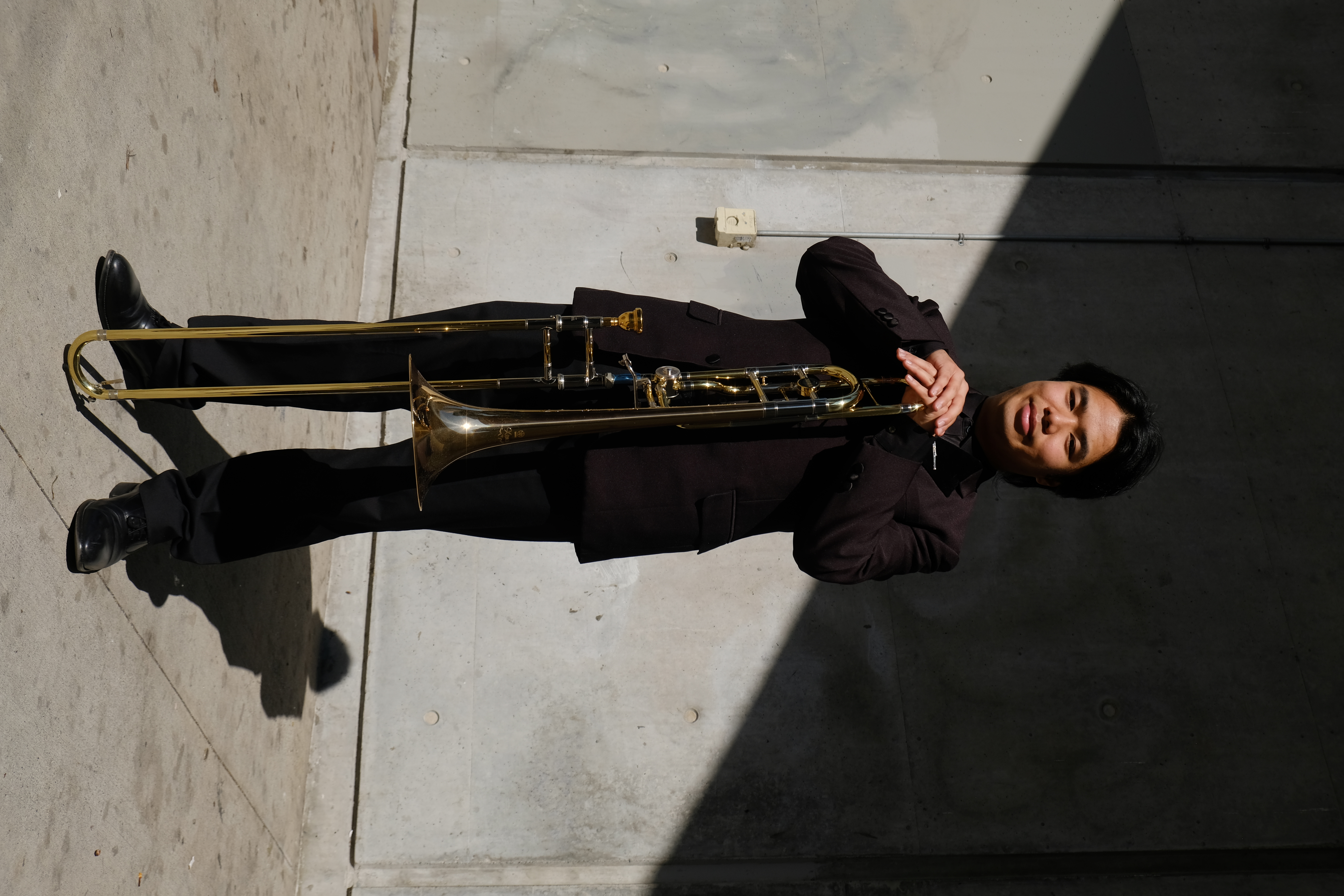 Jobert standing triumphantly with trombone.
