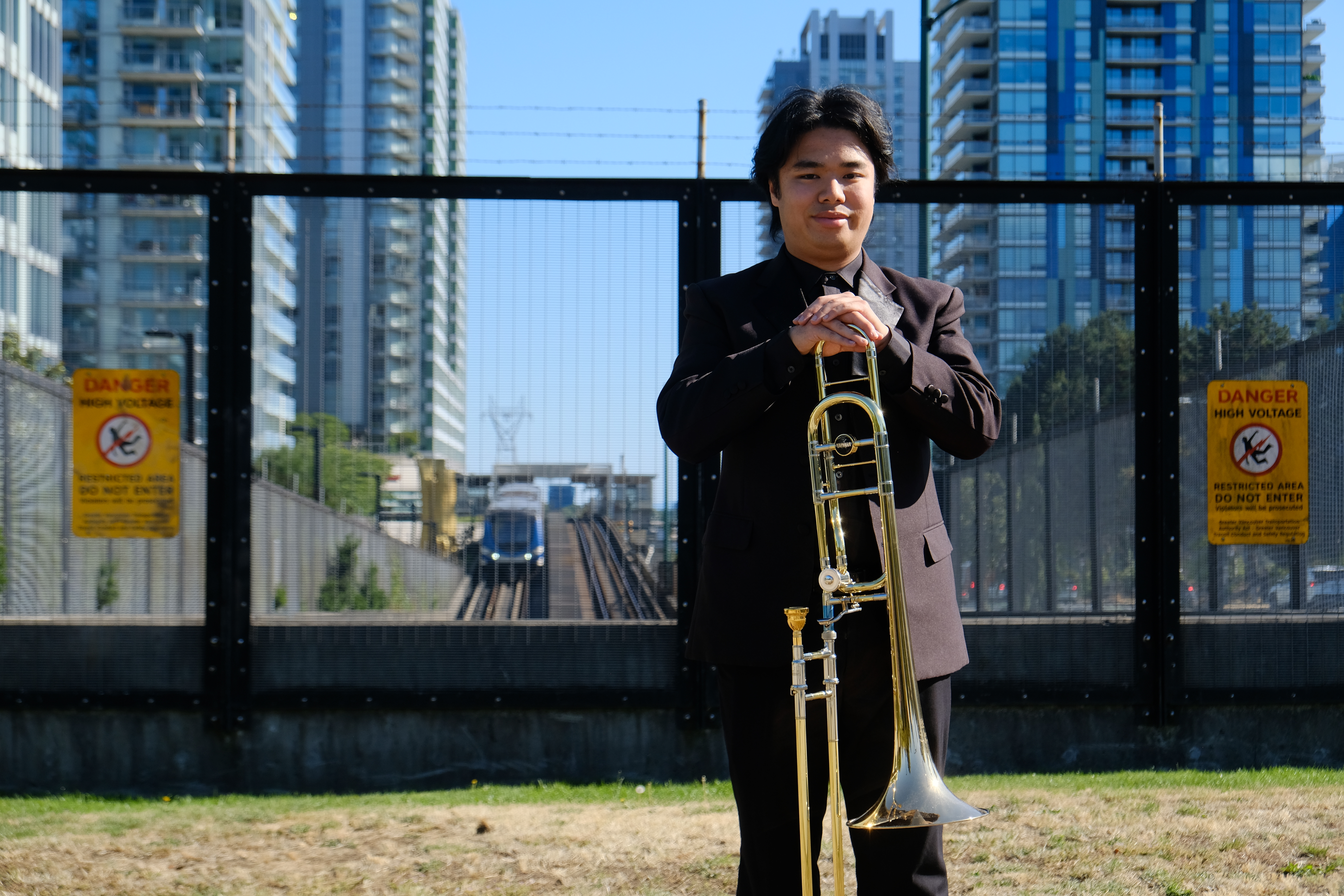 Jobert with trombone near SkyTrain.